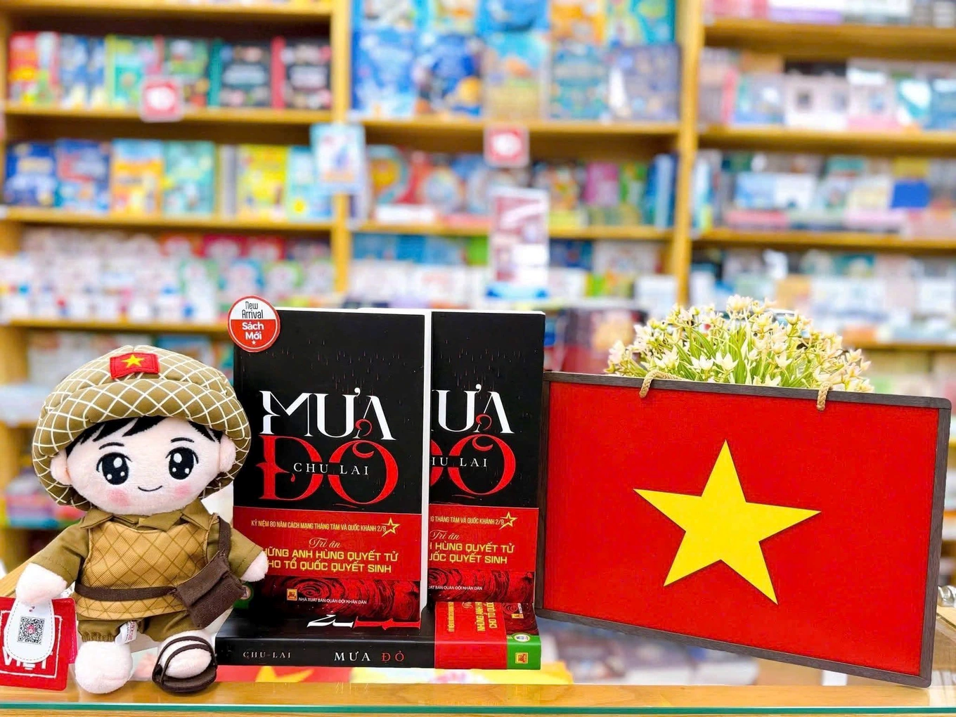 A book and a doll on a shelfDescription automatically generated